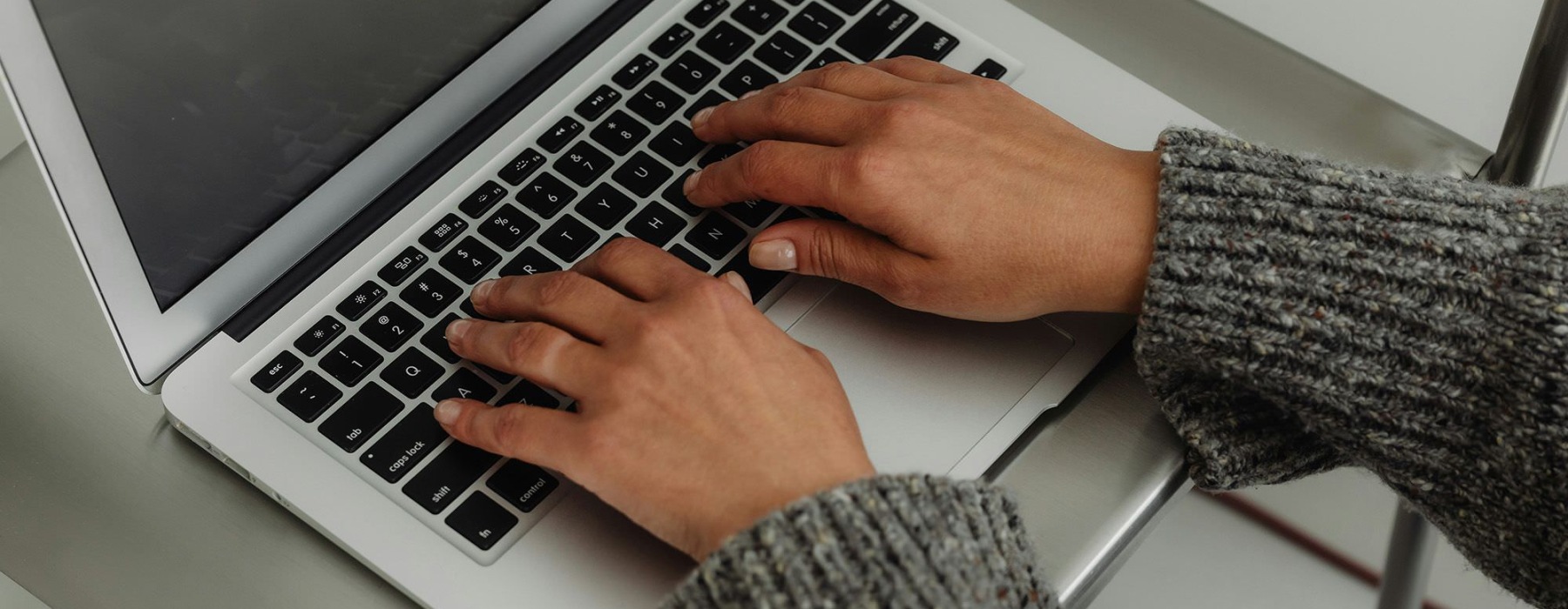 A person typing on a laptop.