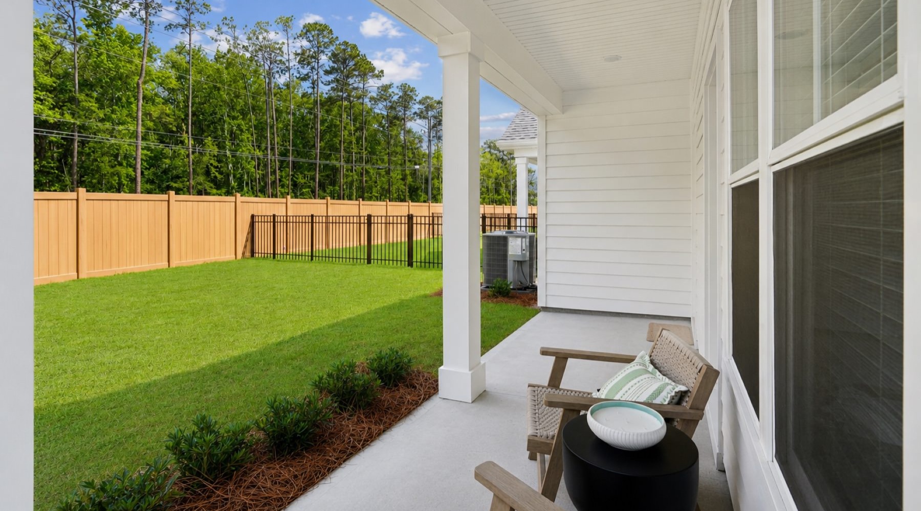 a patio with chairs and a backyard